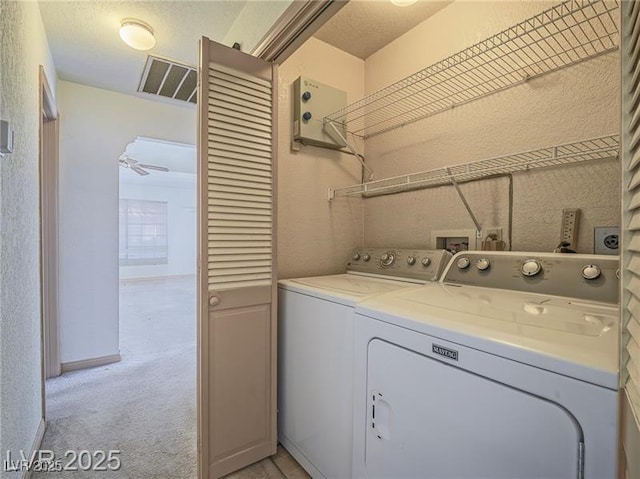 1409 Santa Margarita St Unit G, Las Vegas, NV 89146 - laundry area featuring washing machine and dryer, a textured wall, and light colored carpet