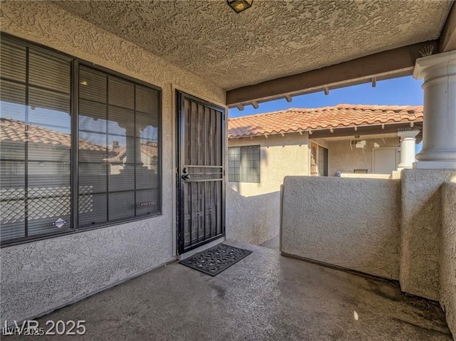 1409 Santa Margarita St Unit G, Las Vegas, NV 89146 - property entrance with stucco siding and a tile roof