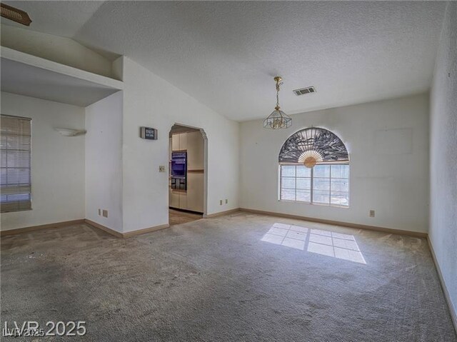 1409 Santa Margarita St Unit G, Las Vegas, NV 89146 - carpeted spare room with arched walkways, lofted ceiling, a chandelier, and a textured ceiling