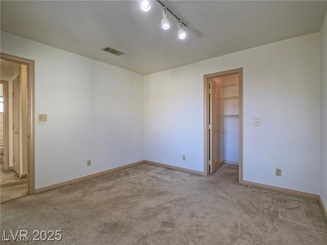 1409 Santa Margarita St Unit G, Las Vegas, NV 89146 - carpeted empty room featuring track lighting and a textured ceiling