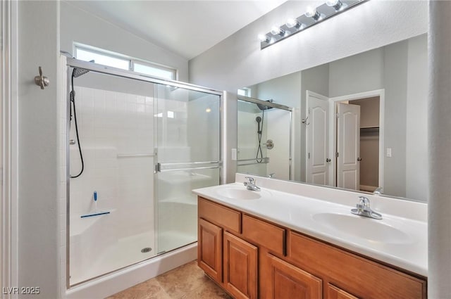 5732 Hornbrook St, North Las Vegas, NV 89031 - full bathroom with a shower stall, double vanity, lofted ceiling, and tile patterned flooring