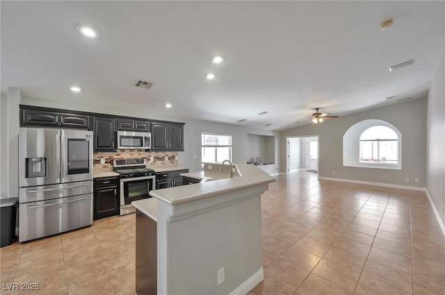 5732 Hornbrook St, North Las Vegas, NV 89031 - kitchen featuring stainless steel appliances, light countertops, healthy amount of natural light, light tile patterned flooring, and recessed lighting