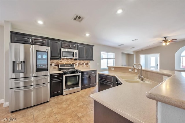 5732 Hornbrook St, North Las Vegas, NV 89031 - kitchen featuring stainless steel appliances, light countertops, backsplash, ceiling fan, and recessed lighting