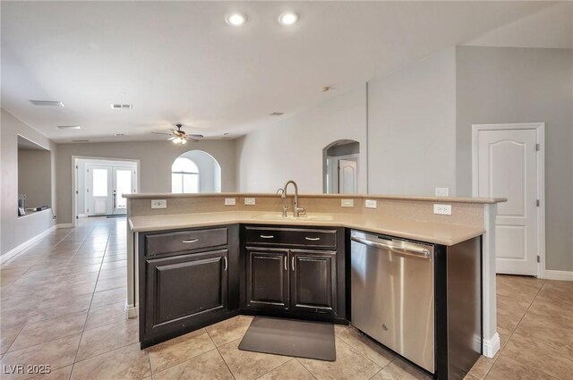 5732 Hornbrook St, North Las Vegas, NV 89031 - kitchen with dishwasher, arched walkways, light countertops, ceiling fan, and light tile patterned floors
