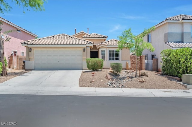 5732 Hornbrook St, North Las Vegas, NV 89031 - mediterranean / spanish home featuring stucco siding, an attached garage, a tiled roof, and driveway