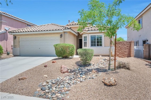 5732 Hornbrook St, North Las Vegas, NV 89031 - mediterranean / spanish-style home featuring a tile roof, stucco siding, driveway, and an attached garage