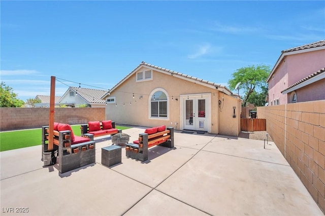 5732 Hornbrook St, North Las Vegas, NV 89031 - back of property with french doors, stucco siding, a fenced backyard, a patio, and an outdoor living space