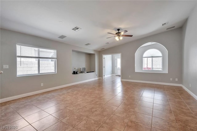 5732 Hornbrook St, North Las Vegas, NV 89031 - spare room featuring light tile patterned floors, ceiling fan, and lofted ceiling