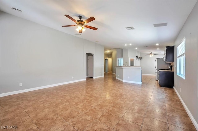 5732 Hornbrook St, North Las Vegas, NV 89031 - unfurnished living room featuring a ceiling fan, arched walkways, recessed lighting, and light tile patterned flooring