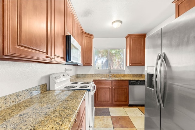 1901 Manhattan Dr, Las Vegas, NV 89106 - kitchen with stainless steel appliances, brown cabinets, and light stone countertops