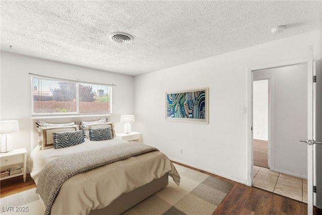 1901 Manhattan Dr, Las Vegas, NV 89106 - bedroom featuring wood finished floors and a textured ceiling