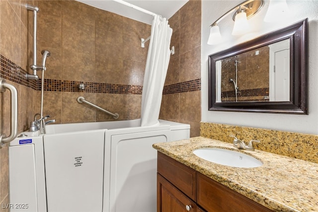 1901 Manhattan Dr, Las Vegas, NV 89106 - bathroom with shower / bath combo with shower curtain, vanity, and tile walls