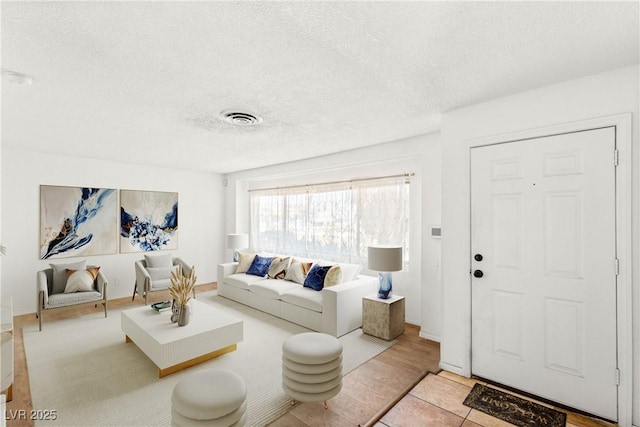 1901 Manhattan Dr, Las Vegas, NV 89106 - living area featuring a textured ceiling and tile patterned floors