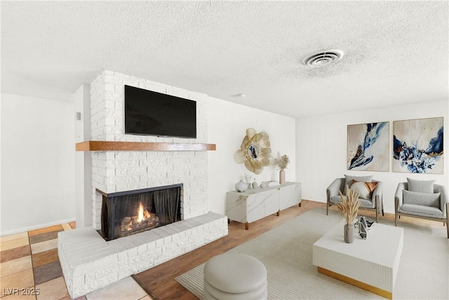 1901 Manhattan Dr, Las Vegas, NV 89106 - living area featuring a fireplace and a textured ceiling