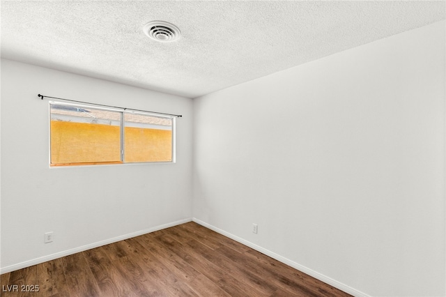 1901 Manhattan Dr, Las Vegas, NV 89106 - empty room featuring dark wood-style flooring and a textured ceiling