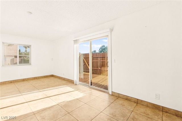 3668 Villa Knolls E Dr, Las Vegas, NV 89120 - empty room featuring healthy amount of natural light, light tile patterned floors, and a textured ceiling
