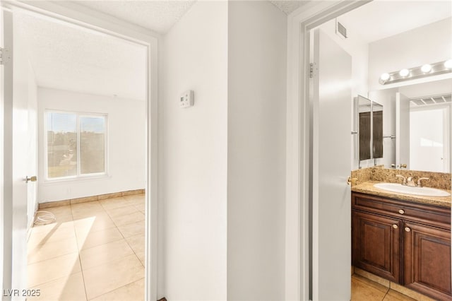 3668 Villa Knolls E Dr, Las Vegas, NV 89120 - bathroom with tile patterned floors, vanity, and a textured ceiling