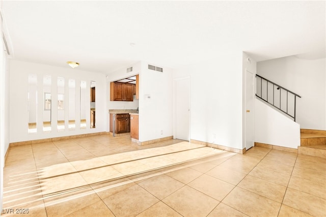 3668 Villa Knolls E Dr, Las Vegas, NV 89120 - unfurnished living room featuring light tile patterned flooring and stairway