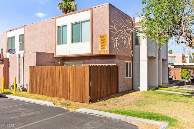 3668 Villa Knolls E Dr, Las Vegas, NV 89120 - view of property exterior featuring stucco siding and uncovered parking