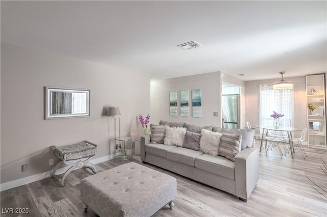 5219 Caliente St Unit 11, Las Vegas, NV 89119 - living room featuring light wood-type flooring and baseboards