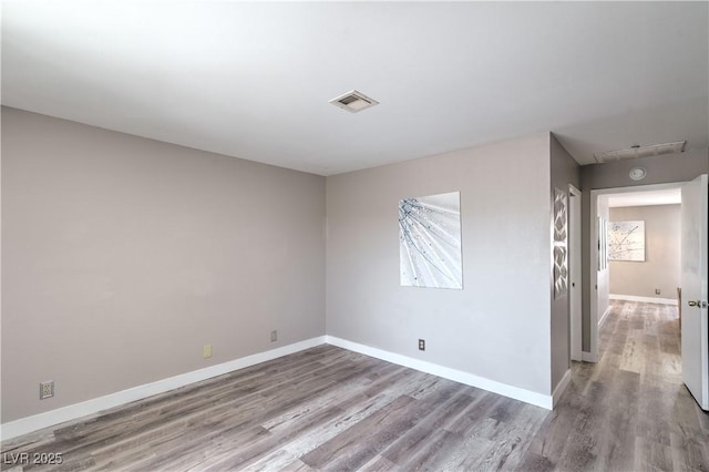 5219 Caliente St Unit 11, Las Vegas, NV 89119 - spare room featuring wood finished floors and baseboards