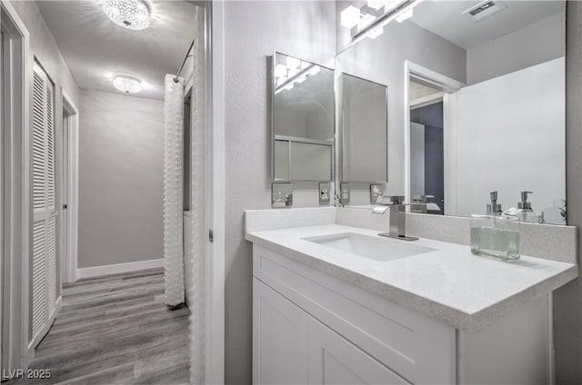5219 Caliente St Unit 11, Las Vegas, NV 89119 - bathroom featuring vanity, wood finished floors, and a closet