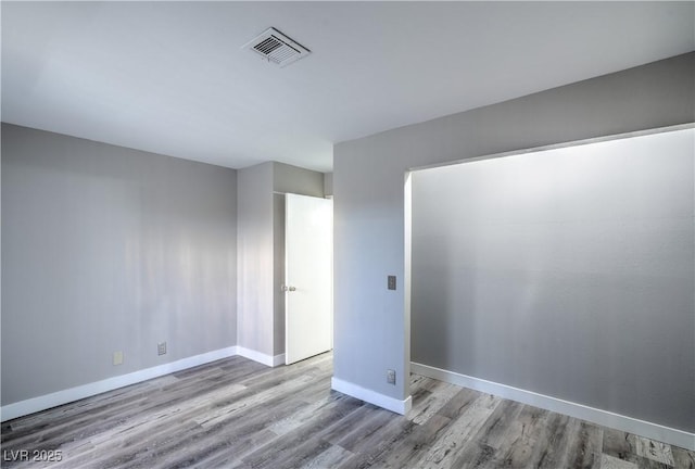 5219 Caliente St Unit 11, Las Vegas, NV 89119 - unfurnished room featuring wood finished floors and baseboards