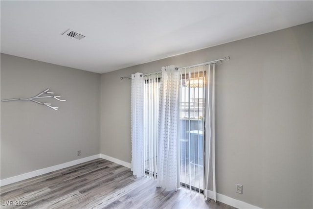 5219 Caliente St Unit 11, Las Vegas, NV 89119 - empty room featuring wood finished floors and baseboards