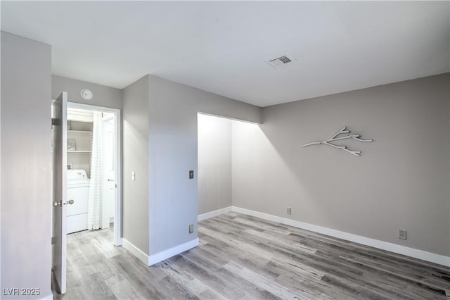 5219 Caliente St Unit 11, Las Vegas, NV 89119 - unfurnished room with washer / dryer, wood finished floors, and a smoke detector