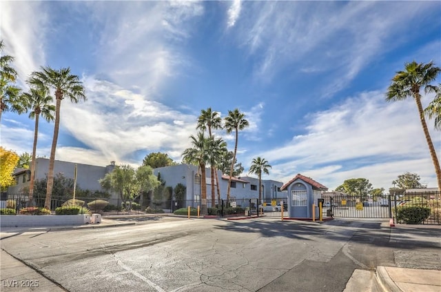 5219 Caliente St Unit 11, Las Vegas, NV 89119 - view of asphalt street with a gate, a gated entry, and curbs