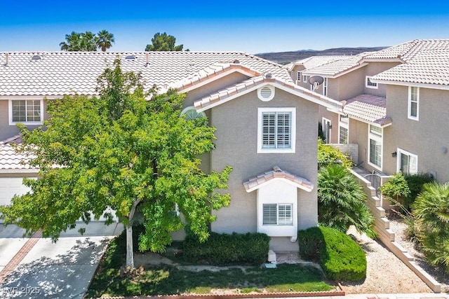 9357 Golden Timber Ln, Las Vegas, NV 89117 - view of front facade featuring a tile roof, stucco siding, and concrete driveway