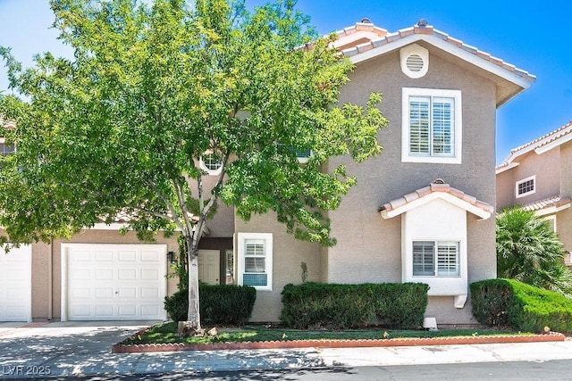 9357 Golden Timber Ln, Las Vegas, NV 89117 - view of front of property with stucco siding, a tiled roof, driveway, and an attached garage