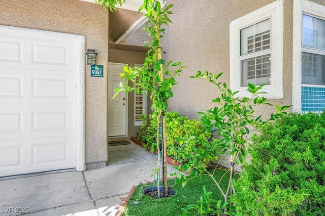 9357 Golden Timber Ln, Las Vegas, NV 89117 - view of exterior entry with stucco siding and an attached garage
