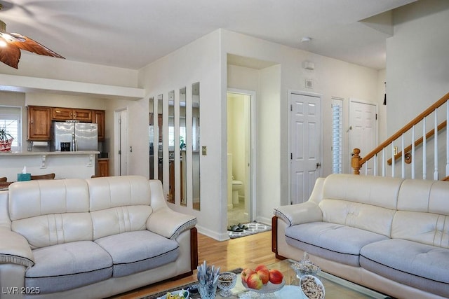 9357 Golden Timber Ln, Las Vegas, NV 89117 - living area with light wood-style flooring, a ceiling fan, and stairs