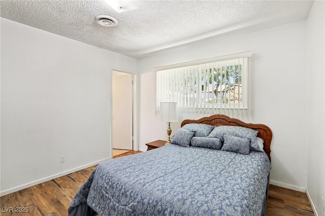 4027 Maple Hill Rd, Las Vegas, NV 89115 - bedroom featuring a textured ceiling and wood finished floors