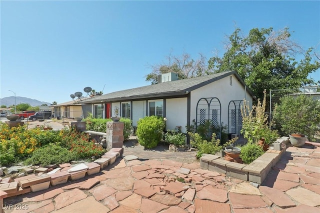 4027 Maple Hill Rd, Las Vegas, NV 89115 - rear view of house featuring a patio, stucco siding, and a mountain view