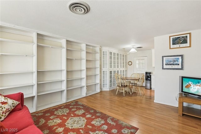 4027 Maple Hill Rd, Las Vegas, NV 89115 - living room featuring wood finished floors and baseboards