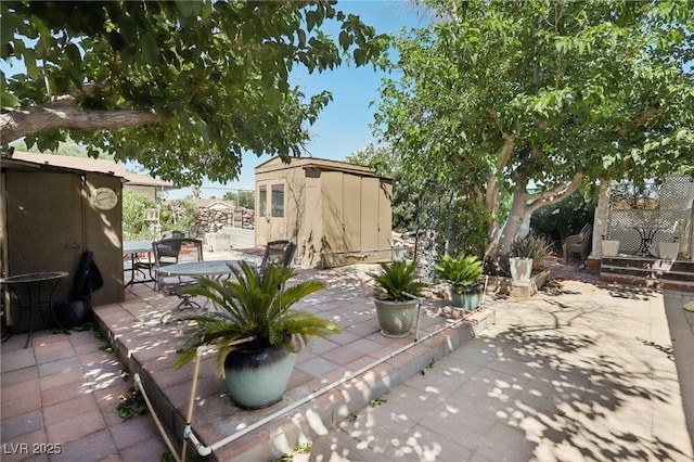 4027 Maple Hill Rd, Las Vegas, NV 89115 - view of yard featuring a storage unit and a patio area