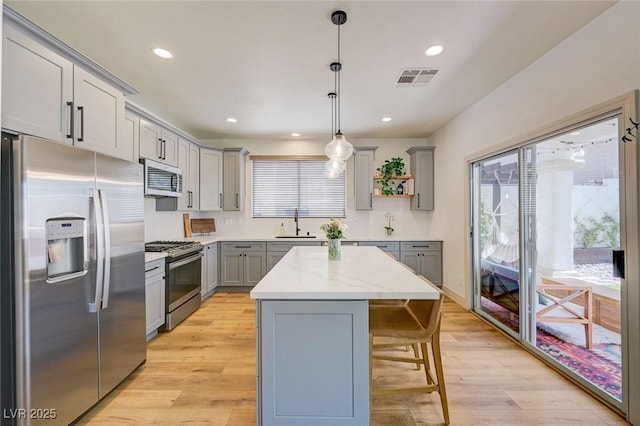 189 Andada Dr, Henderson, NV 89012 - kitchen featuring stainless steel appliances, gray cabinets, healthy amount of natural light, a kitchen breakfast bar, and recessed lighting
