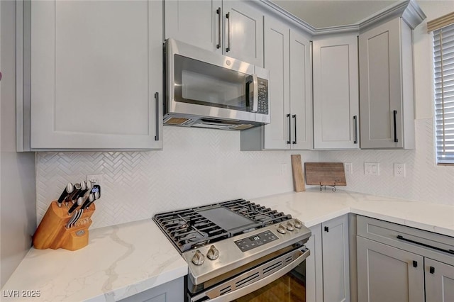 189 Andada Dr, Henderson, NV 89012 - kitchen with appliances with stainless steel finishes, gray cabinets, and backsplash