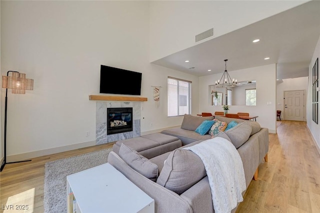189 Andada Dr, Henderson, NV 89012 - living room with light wood-type flooring, a chandelier, recessed lighting, and a high end fireplace