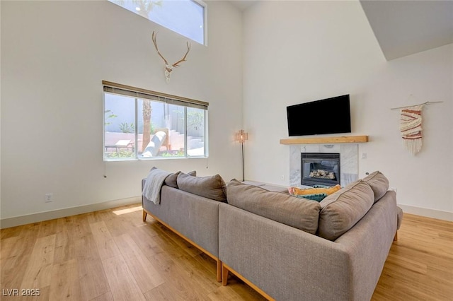189 Andada Dr, Henderson, NV 89012 - living area with a high ceiling, light wood-style flooring, and a tile fireplace