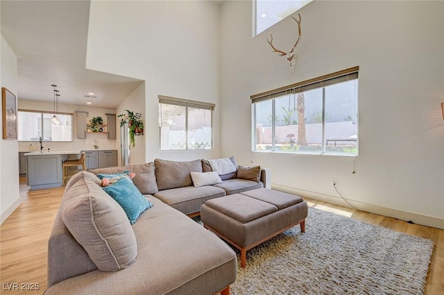 189 Andada Dr, Henderson, NV 89012 - living area featuring healthy amount of natural light, light wood-style floors, and a towering ceiling