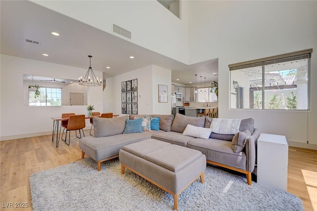 189 Andada Dr, Henderson, NV 89012 - living room featuring light wood finished floors, a chandelier, and recessed lighting