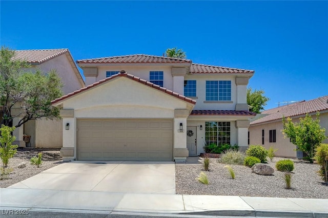 189 Andada Dr, Henderson, NV 89012 - mediterranean / spanish-style house featuring a garage, a tiled roof, stucco siding, and concrete driveway