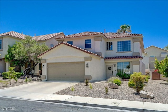 189 Andada Dr, Henderson, NV 89012 - mediterranean / spanish house featuring a tile roof, an attached garage, stucco siding, and concrete driveway