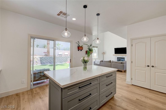 189 Andada Dr, Henderson, NV 89012 - kitchen with gray cabinets, light countertops, light wood-type flooring, a kitchen island, and recessed lighting