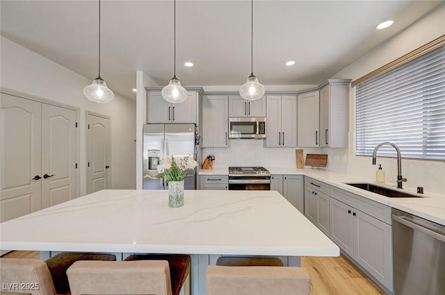 189 Andada Dr, Henderson, NV 89012 - kitchen featuring gray cabinetry, stainless steel appliances, a kitchen breakfast bar, backsplash, and recessed lighting