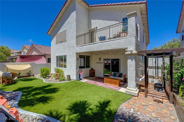 189 Andada Dr, Henderson, NV 89012 - rear view of house with a balcony, stucco siding, a patio area, and an outdoor living space