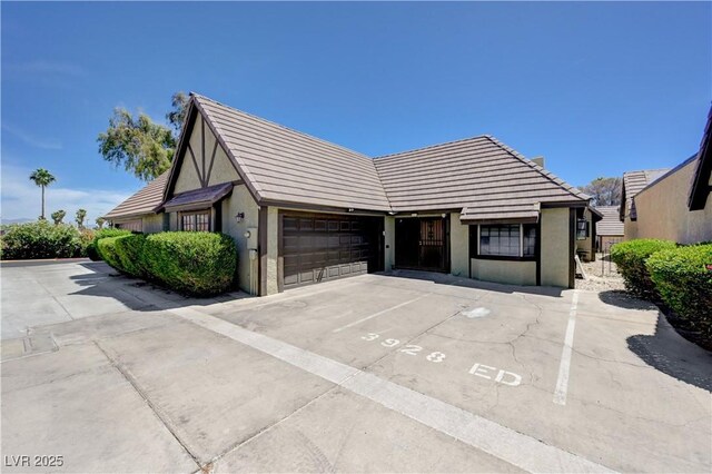 3928 Edgemoor Way, Las Vegas, NV 89121 - view of front of home with stucco siding, a tiled roof, and uncovered parking